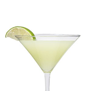 Wasabi martini with lime wedge on rim