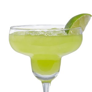 Margarita glass filled with shamrock-arita and garnished with a fresh lime wedge