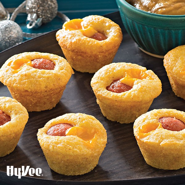 Mini corn muffins with cooked hot dog and melted cheese