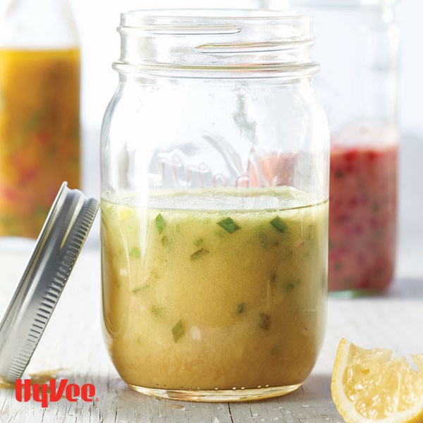 Yellow lemon and chive vinaigrette in a mason jar 