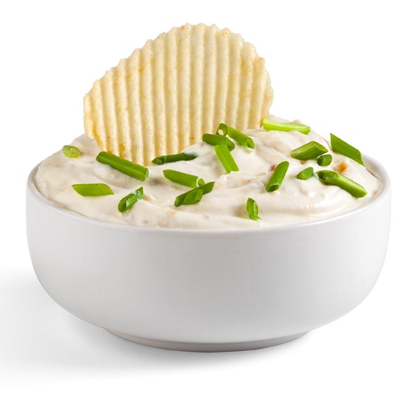 White bowl filled with dip and topped with chopped chives and crinkled potato chip