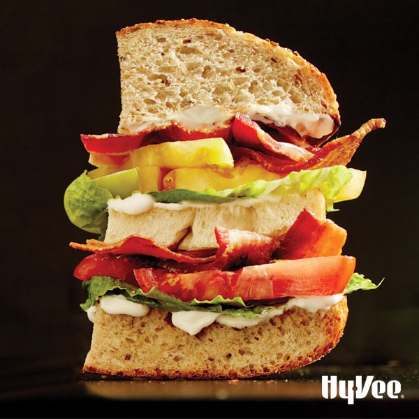 Mayo, tomato wedges, lettuce, and bacon in between slices of thick-cut bread