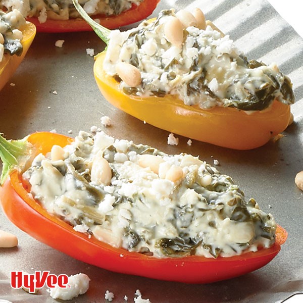 Halved mini bell peppers stuffed with spinach-artichoke dip