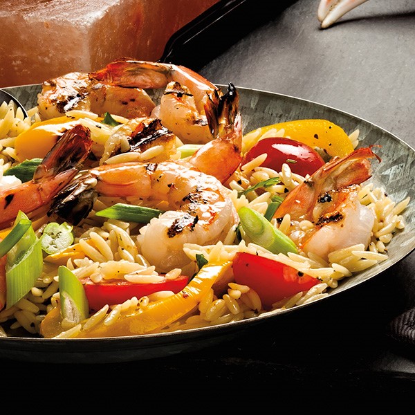 Large bowl filled with orzo, vegetables and shrimp