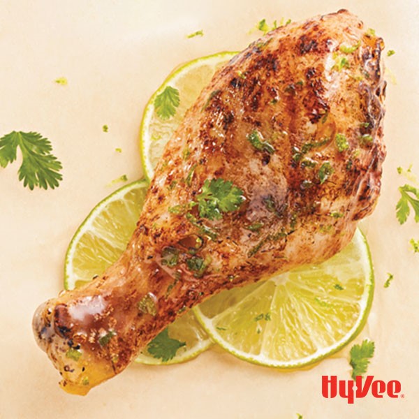 Coconut lime chicken drumsticks topped with cilantro and served over lime slices