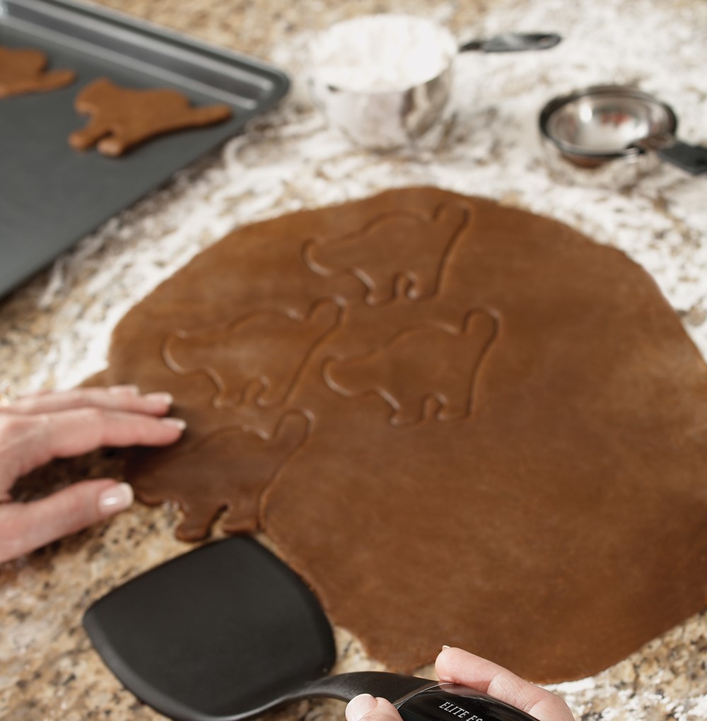 Cutting out Black Cat Cookies from Dark Chocolate Cookie Dough