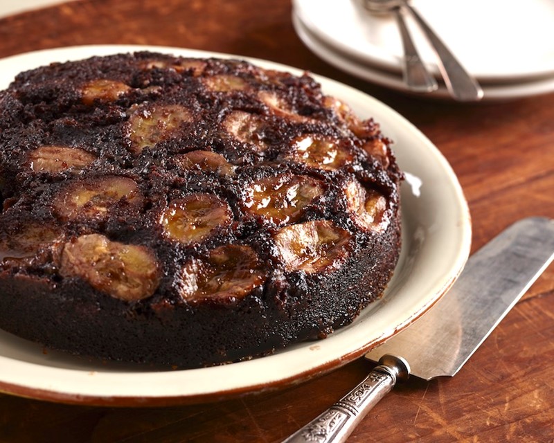 Chocolate Banana Upside Down Cake on a Plate with a Cake Server on the Side