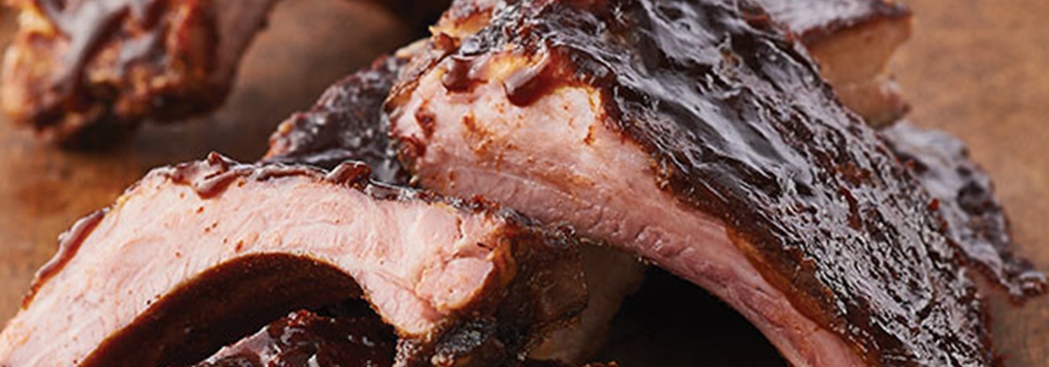 Baby Back Ribs with Barbecue Sauce on Wood Surface