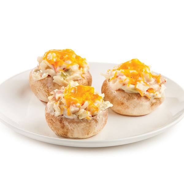 Plate of Imitation Crab Stuffed Mushrooms with Melted Yellow Cheese on Top