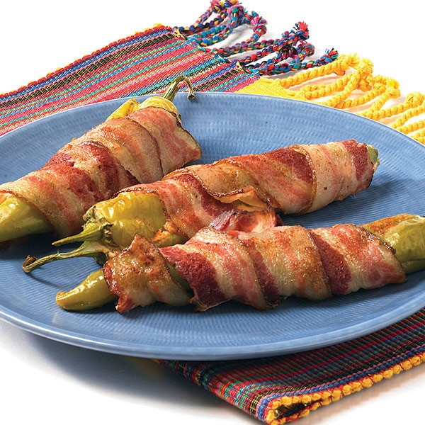 plate of stuffed peppers wrapped in bacon