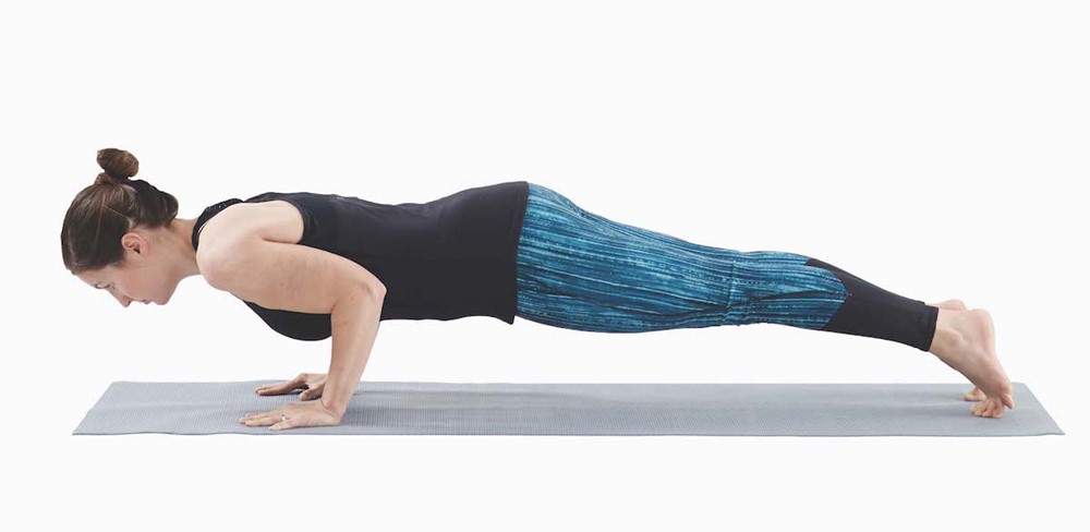 woman in a plank position with elbows bent so that her upper arms are parallel to the floor