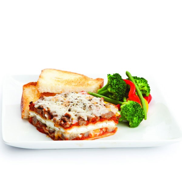 Lasagna on Plate with Veggies and Bread