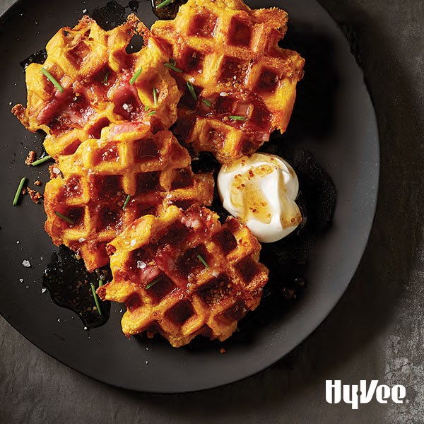 Pumpkin waffles with ham and cheese on plate