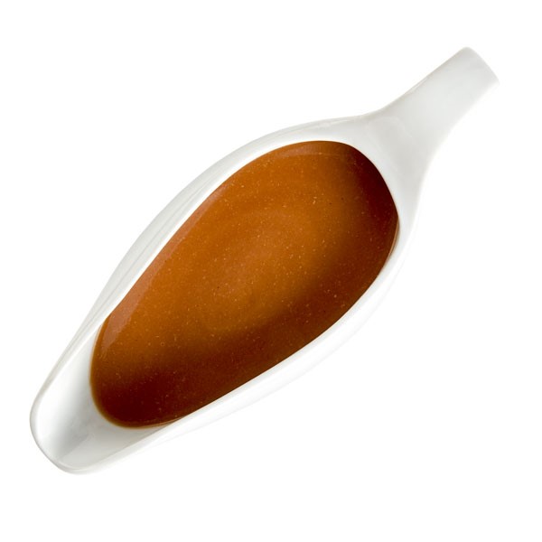 Light brown gravy in a white gravy boat