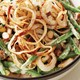 Green beans with creamy white sauce topped with homemade crispy onions and sliced almonds