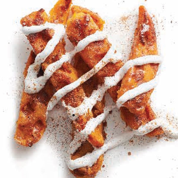 Sweet potato steak fries covered in cinnamon-syrup sauce and piped with melted marshmallow crème