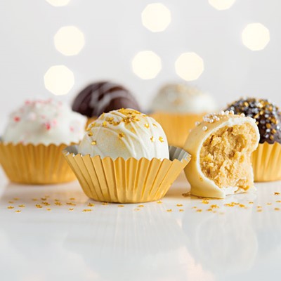 Gold-colored tins filled with white chocolate and milk chocolate cookie truffles