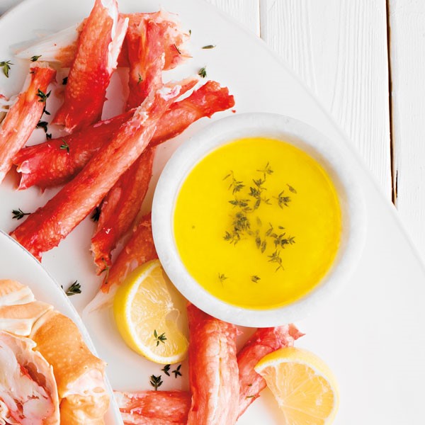 Plate of crab meat served with a side of citrus herb butter
