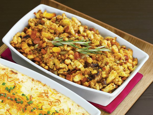 Dish of stuffing, garnished with rosemary sprigs