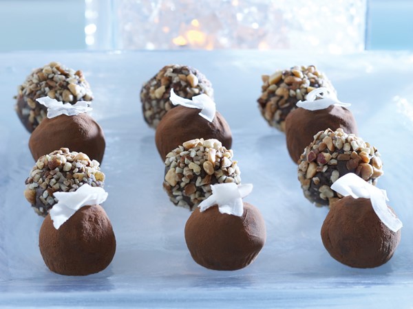 Chocolate mint truffles garnished with chopped nuts and coconut shavings