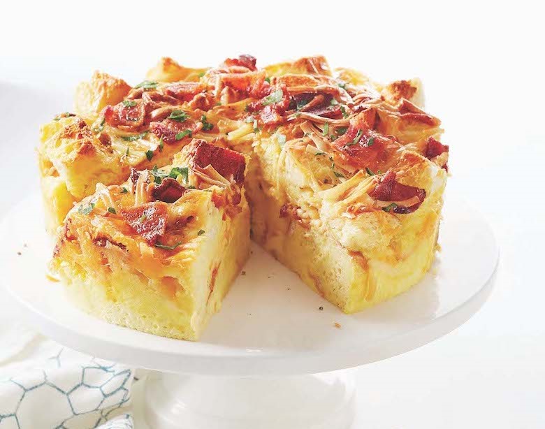 bacon and cheese strata on a cake stand