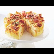 bacon and cheese strata on a cake stand