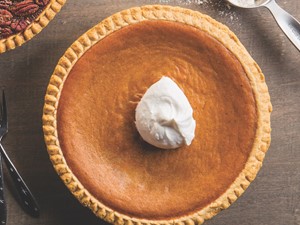 whole pumpkin pie with a dollop of whipped cream